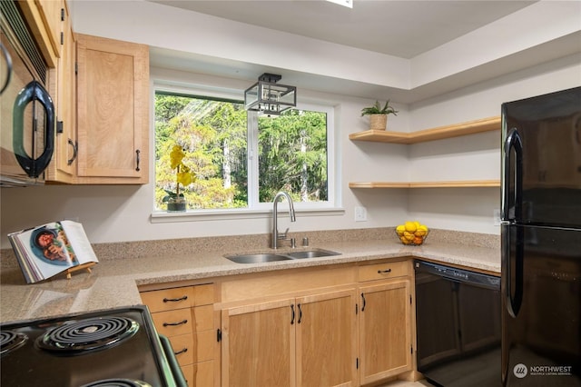 kitchen with sink, light brown cabinetry, and black appliances