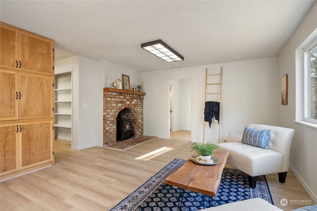 living room with a textured ceiling and light hardwood / wood-style floors