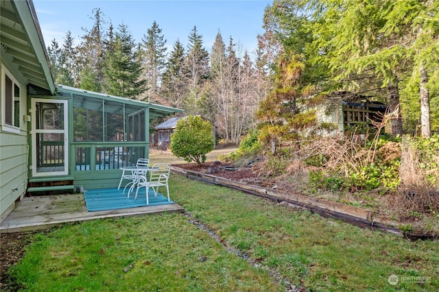 view of yard featuring a deck and a sunroom