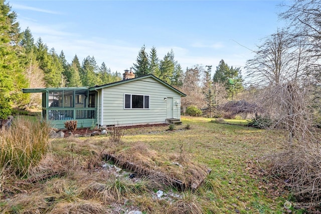 view of property exterior featuring a sunroom