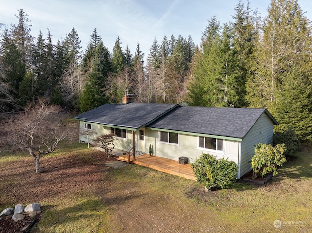 single story home with a front yard, a deck, and central air condition unit