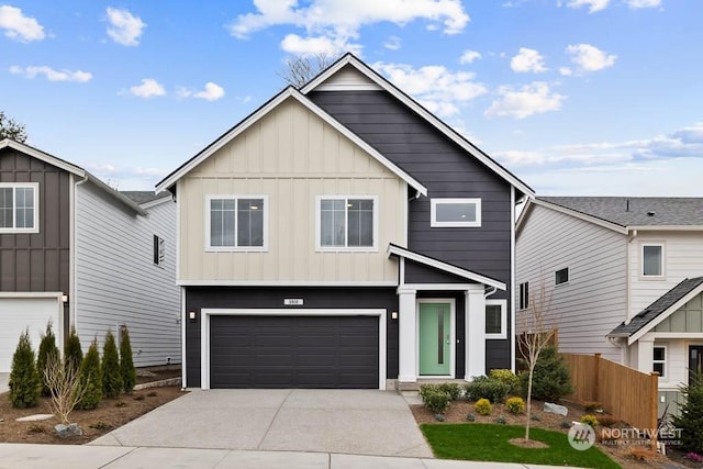 view of front of house with board and batten siding, concrete driveway, fence, and an attached garage