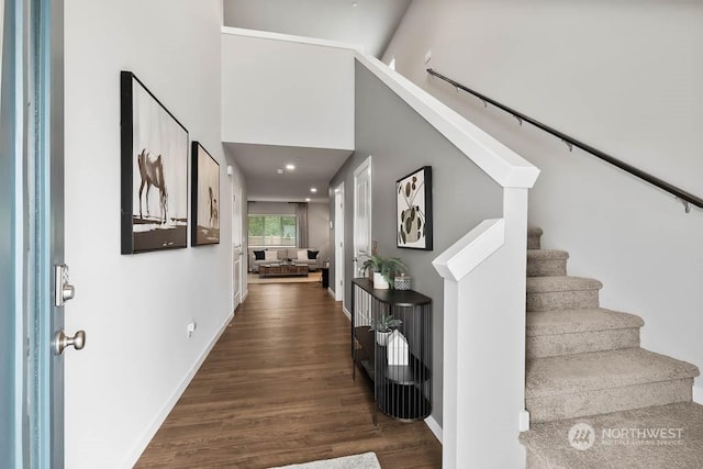 entrance foyer with dark wood-type flooring, recessed lighting, stairway, and baseboards