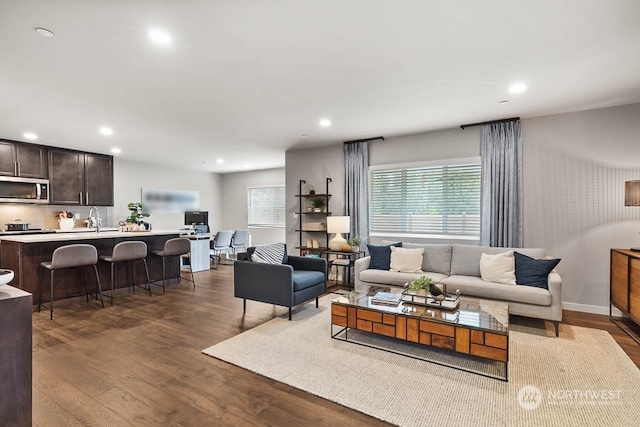 living room featuring baseboards, dark wood-style flooring, and recessed lighting