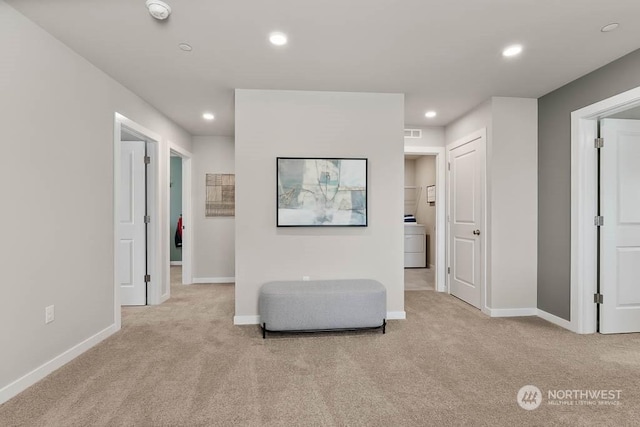 living area with washer / dryer, recessed lighting, and light colored carpet