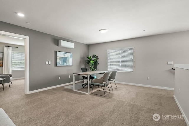 dining area featuring light carpet, baseboards, and a wall mounted AC