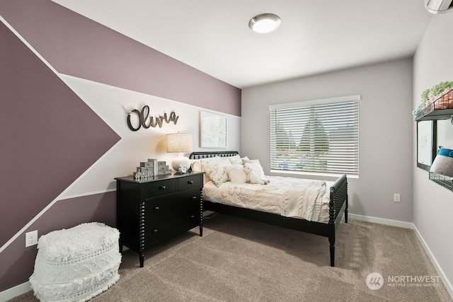 bedroom featuring a wall unit AC, carpet, and baseboards