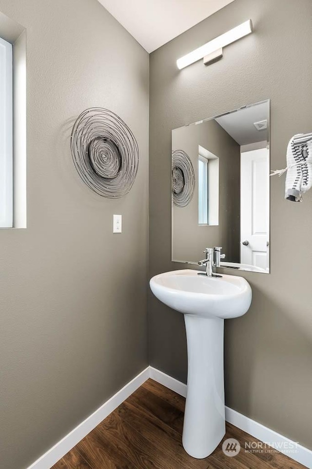 bathroom with hardwood / wood-style flooring