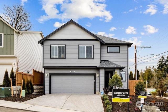 front of property featuring cooling unit and a garage