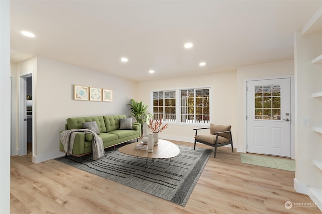 living room with a wealth of natural light and light wood-type flooring