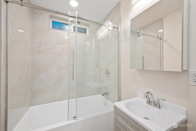 bathroom featuring vanity and shower / bath combination with glass door