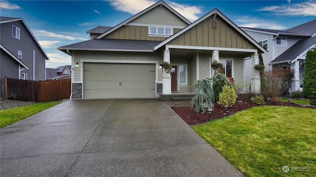 craftsman house with a garage and a front yard