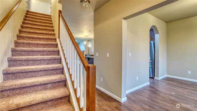 staircase with hardwood / wood-style floors