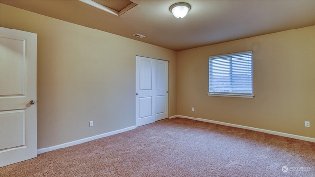 unfurnished bedroom featuring carpet floors and a closet