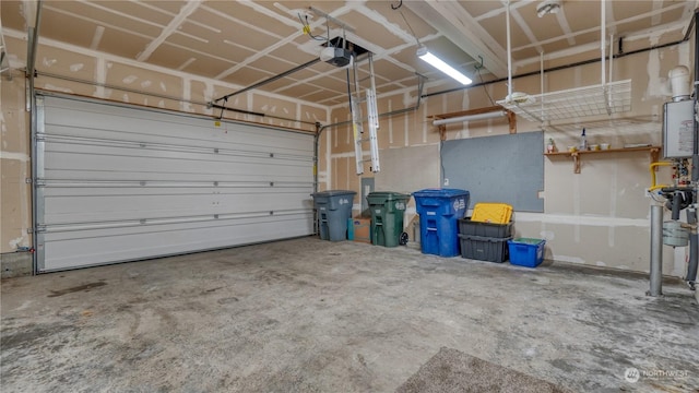 garage featuring a garage door opener and water heater