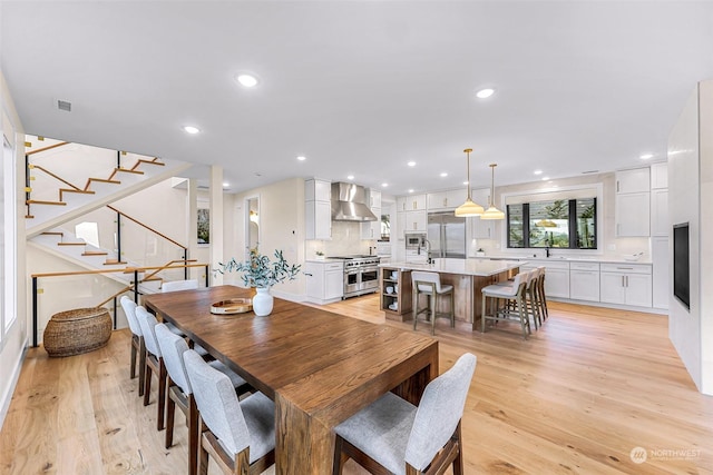 dining space featuring sink and light wood-type flooring