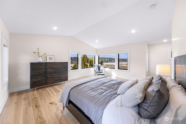 bedroom with lofted ceiling and light hardwood / wood-style flooring