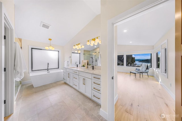 bathroom featuring vanity, plus walk in shower, and vaulted ceiling