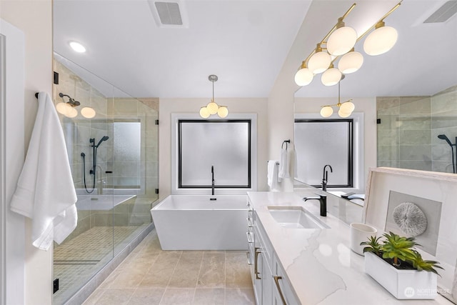 bathroom featuring tile patterned flooring, vanity, and shower with separate bathtub