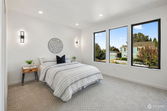 carpeted bedroom with multiple windows