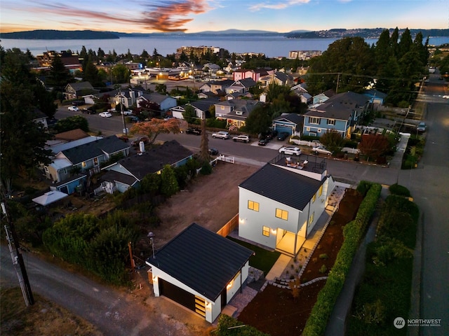 aerial view at dusk with a water view