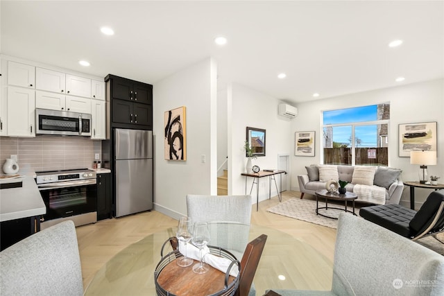 interior space featuring a wall mounted air conditioner, white cabinets, and light parquet flooring