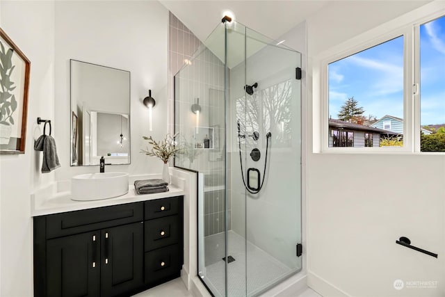 bathroom with an enclosed shower and vanity