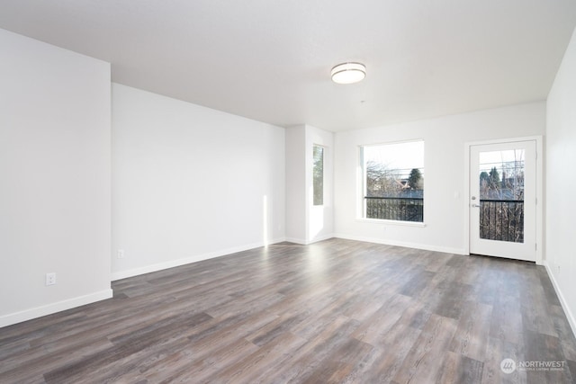 spare room featuring dark wood-type flooring