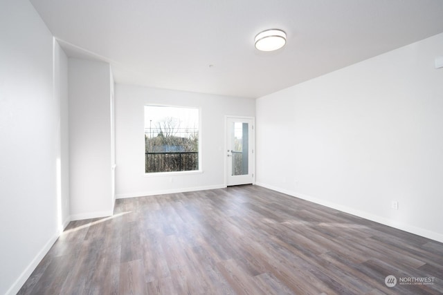 unfurnished room with dark hardwood / wood-style floors