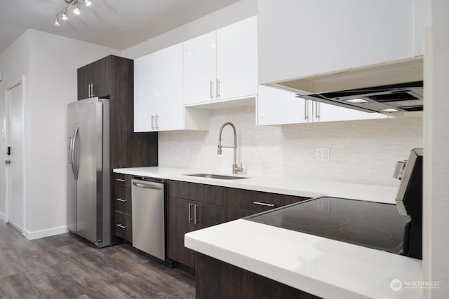 kitchen with sink, appliances with stainless steel finishes, white cabinetry, dark brown cabinets, and dark hardwood / wood-style floors