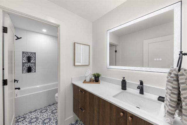 full bathroom featuring vanity, tiled shower / bath, tile patterned flooring, and toilet