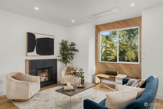 living room featuring hardwood / wood-style floors and wooden walls