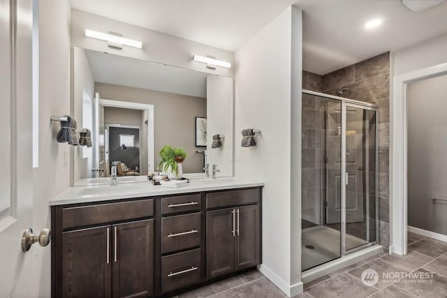 bathroom featuring vanity, an enclosed shower, and tile patterned floors