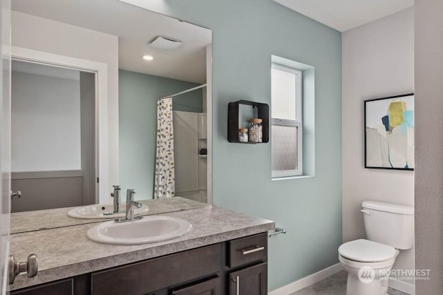 bathroom with vanity, toilet, and curtained shower