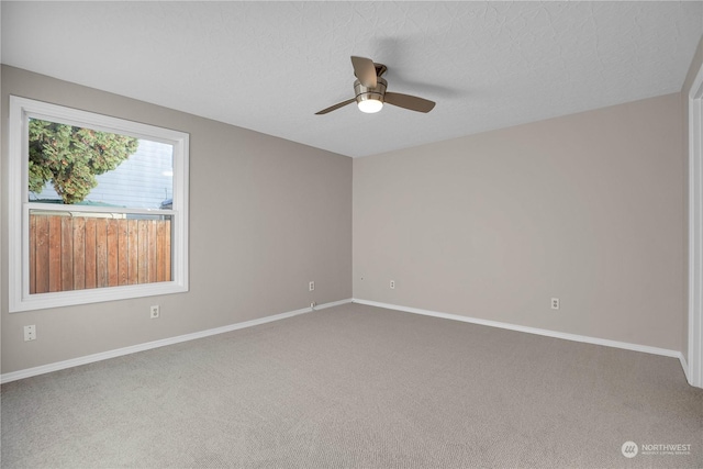 unfurnished room featuring ceiling fan, a textured ceiling, and carpet