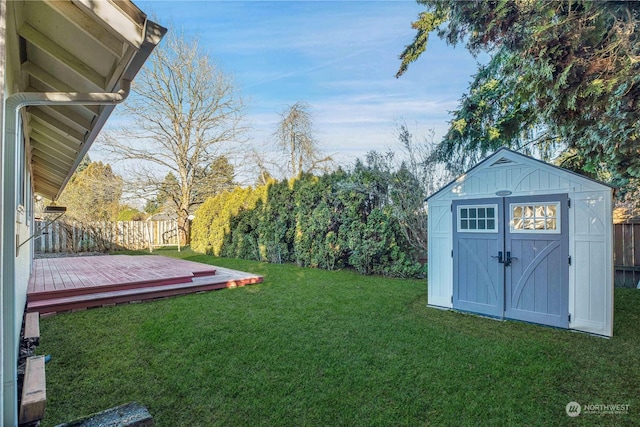 view of yard with a shed and a wooden deck