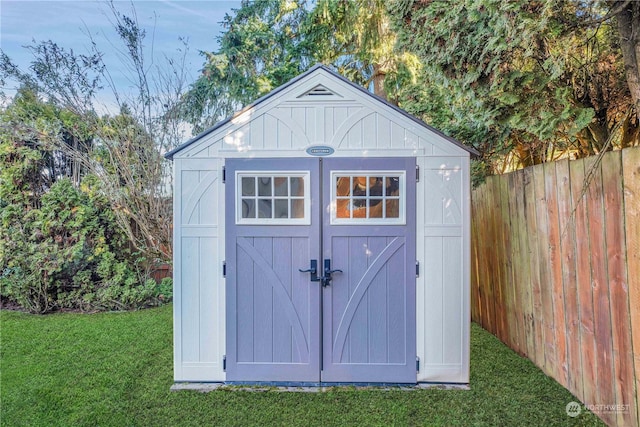 view of outbuilding featuring a yard