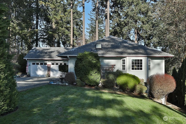 view of front of property with a garage and a front lawn