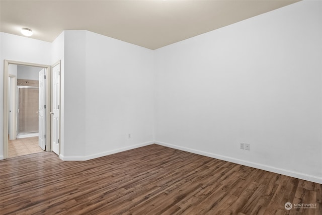 empty room with dark wood-type flooring