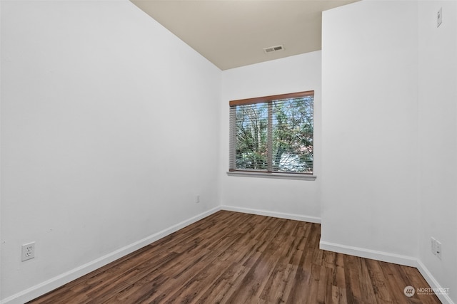 empty room with dark wood-type flooring