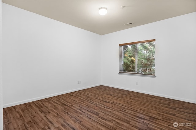 spare room featuring dark hardwood / wood-style flooring