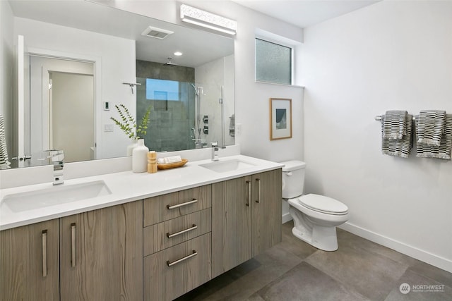 bathroom featuring vanity, toilet, a shower with door, and concrete floors