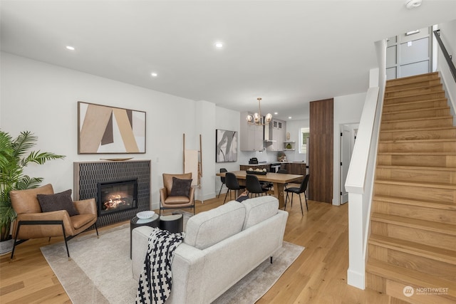 living room featuring a notable chandelier and light hardwood / wood-style floors