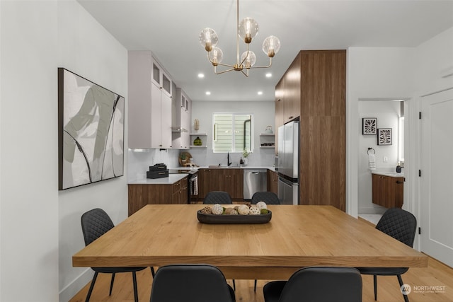 dining area with sink and a chandelier