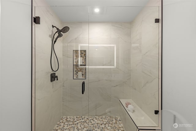 bathroom with a shower with door