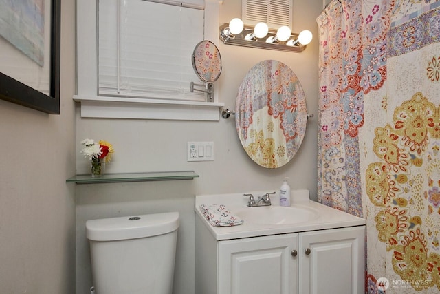 full bath featuring vanity and toilet