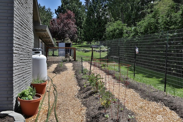 view of yard with a garden and fence