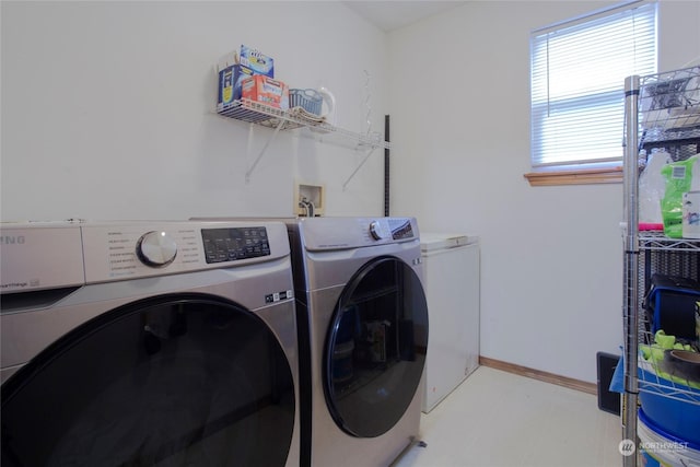 clothes washing area with separate washer and dryer