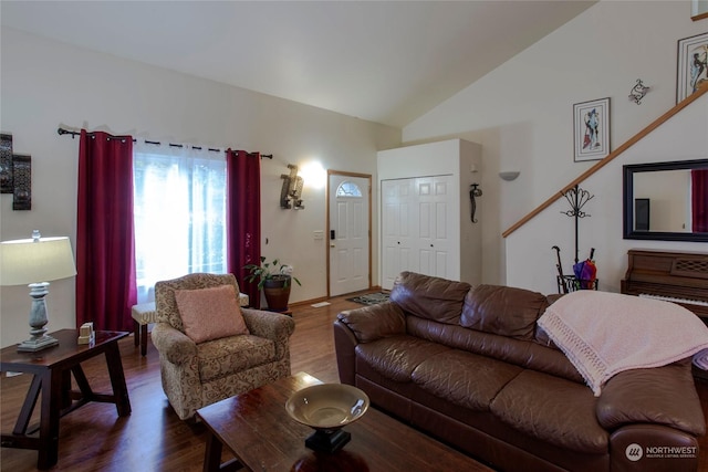 living room with dark wood-type flooring and high vaulted ceiling