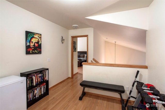 exercise area with light hardwood / wood-style flooring